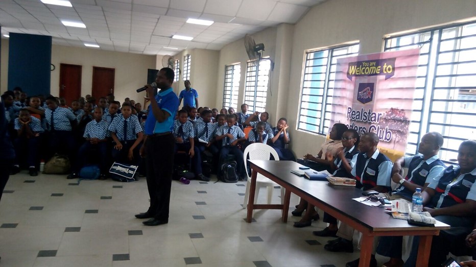 The Head Teacher of wellspring Addressing students during Realstar visit
